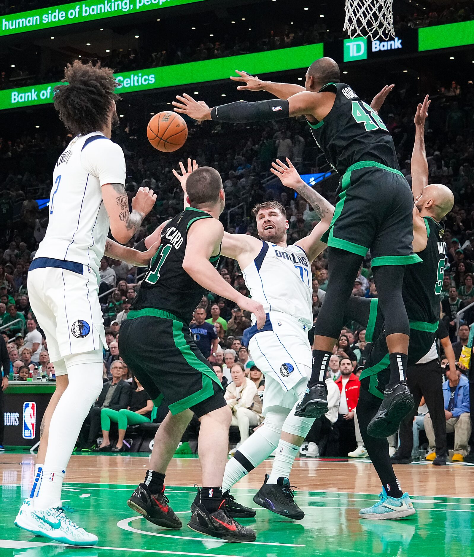 Dallas Mavericks guard Luka Doncic (77) passes to center Dereck Lively II (2) out of a...