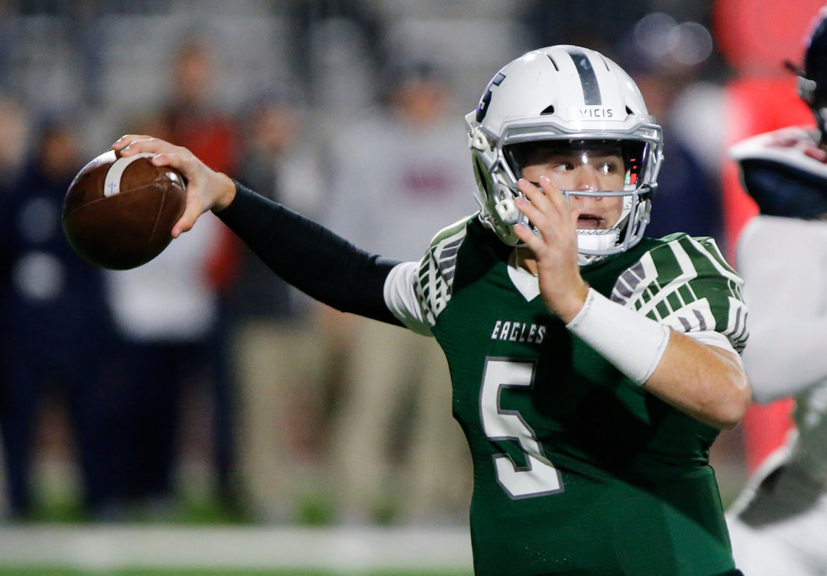 Prosper High School quarterback Jackson Berry (5) throws a pass during the first half as...