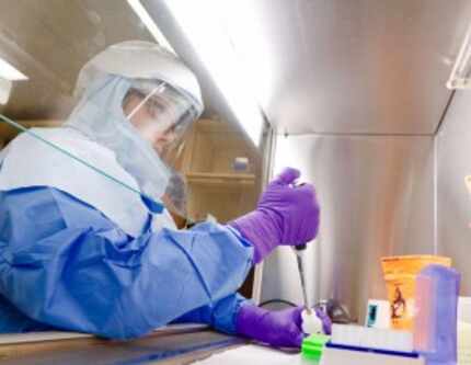  Chad Donelson, microbiologist, demonstrates an extraction the Dallas County Health and...