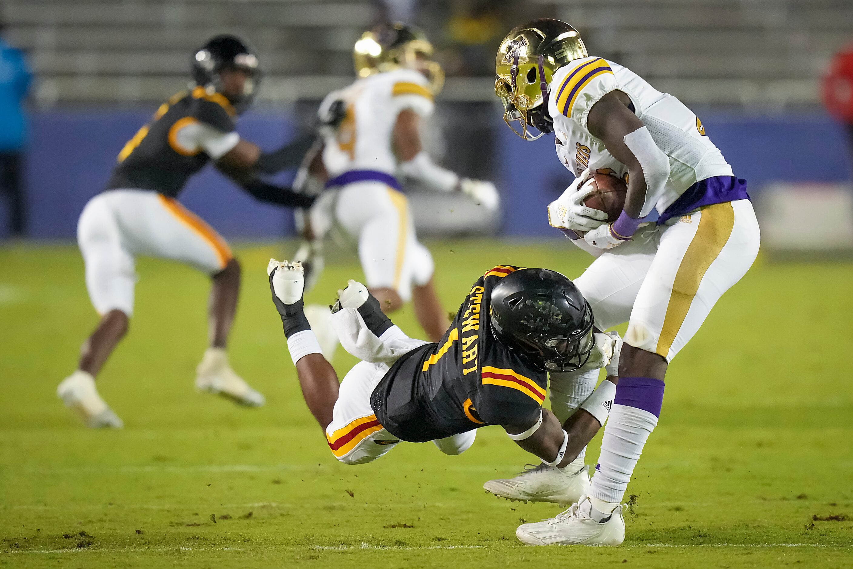 Prairie View’s Chris Herron (16) is brought down by Grambling defensive back Myron Stewart...