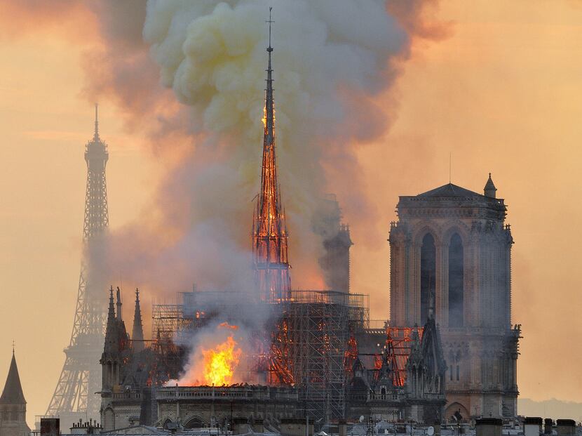 With the Eiffel Tower in the distance, flames and smoke rise from the blaze at Notre Dame...