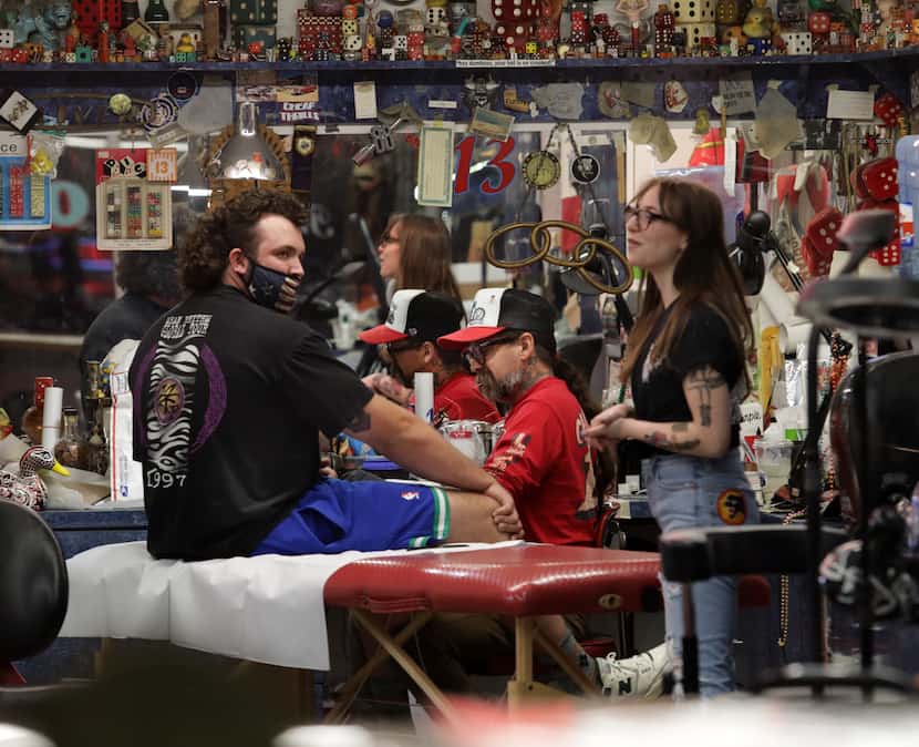 Guests and employees enjoy the evening at Deep Ellum's Elm Street Tattoos in Dallas, TX, on...
