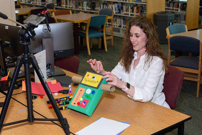 Librarian Melanie Storts demonstrates a craft for the Plano Public Library’s Facebook...