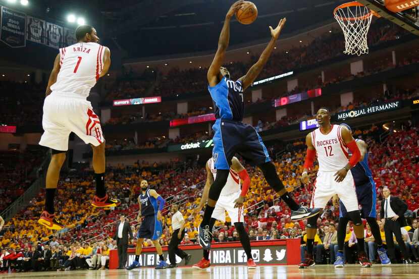 Dallas Mavericks forward Al-Farouq Aminu (7) grabs a rebound in front of Houston Rockets...