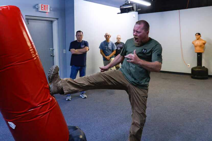 Senior instructor William Chadwick (front) demonstrates a piston kick as participants Kevin...