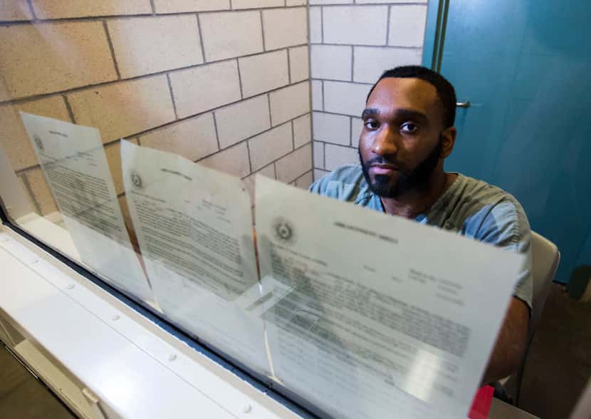 Carl Govan holds up arraignments on his case at the Dallas County Jail. He is accused of...