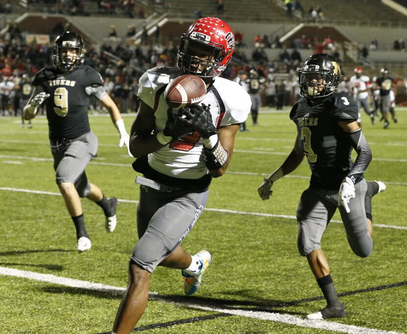 Cedar Hill's Camron Buckley catches a touchdaown against Mansfield during their game at...