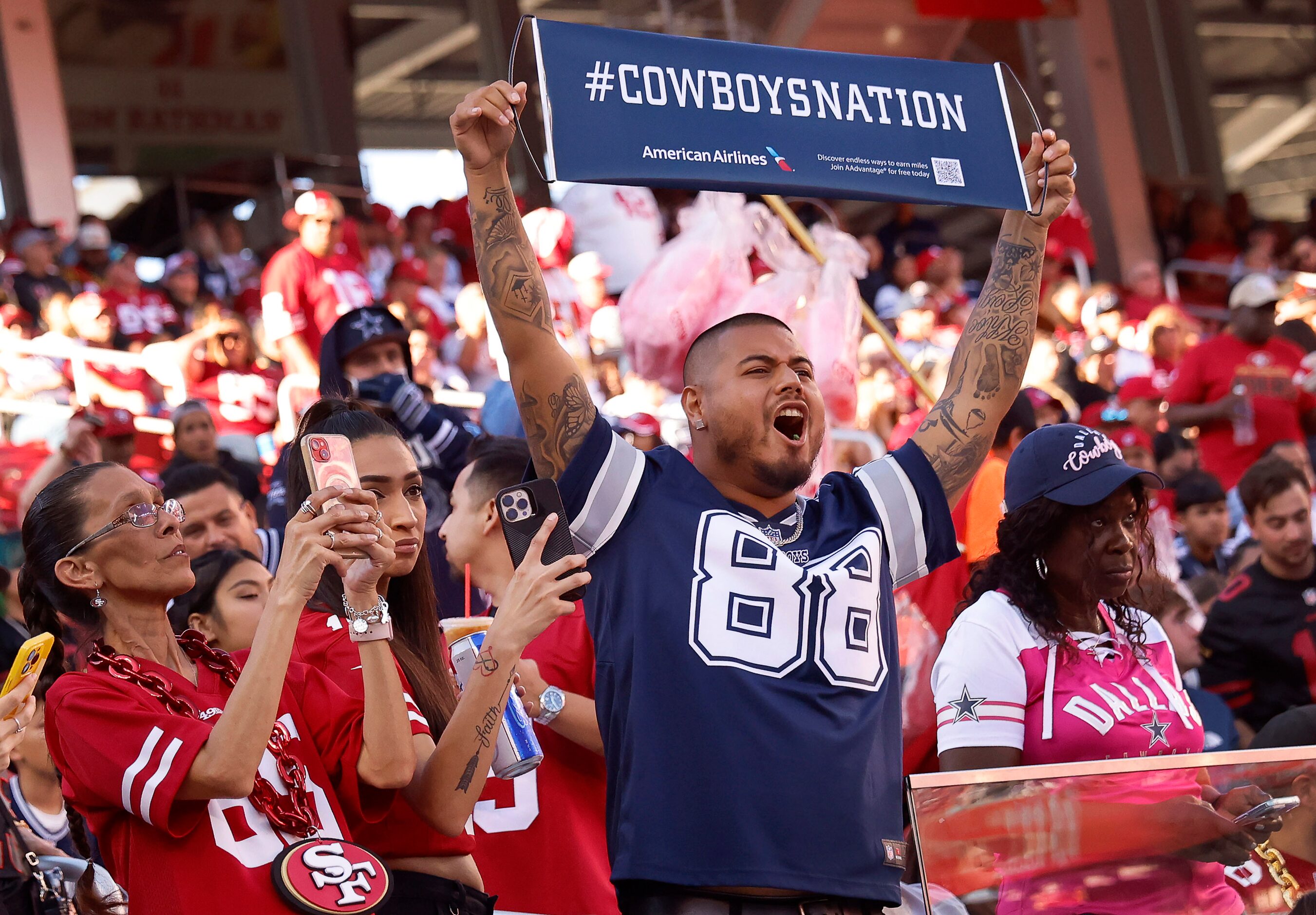 Dallas Cowboys fans cheer as the team finishes pregame warmups before facing the San...