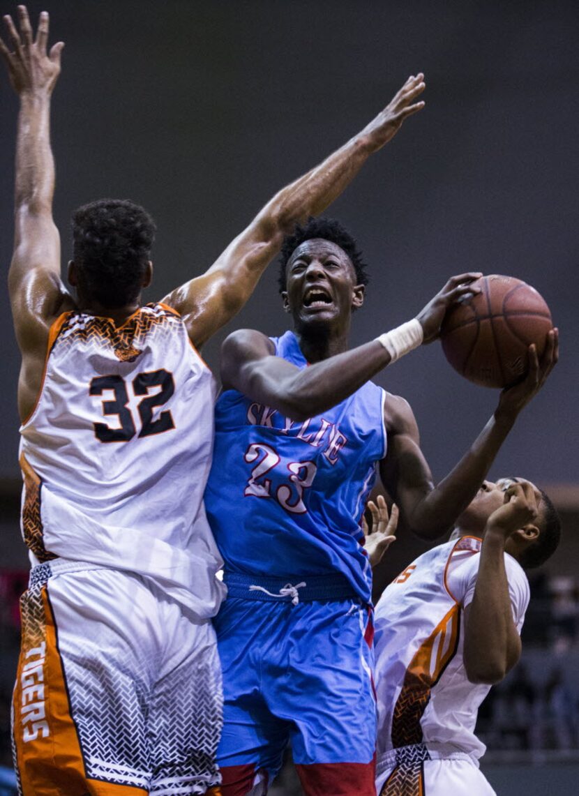 Skyline's Marcus Garrett (23) goes up for a shot against Lancaster's Nate Morris (32) during...