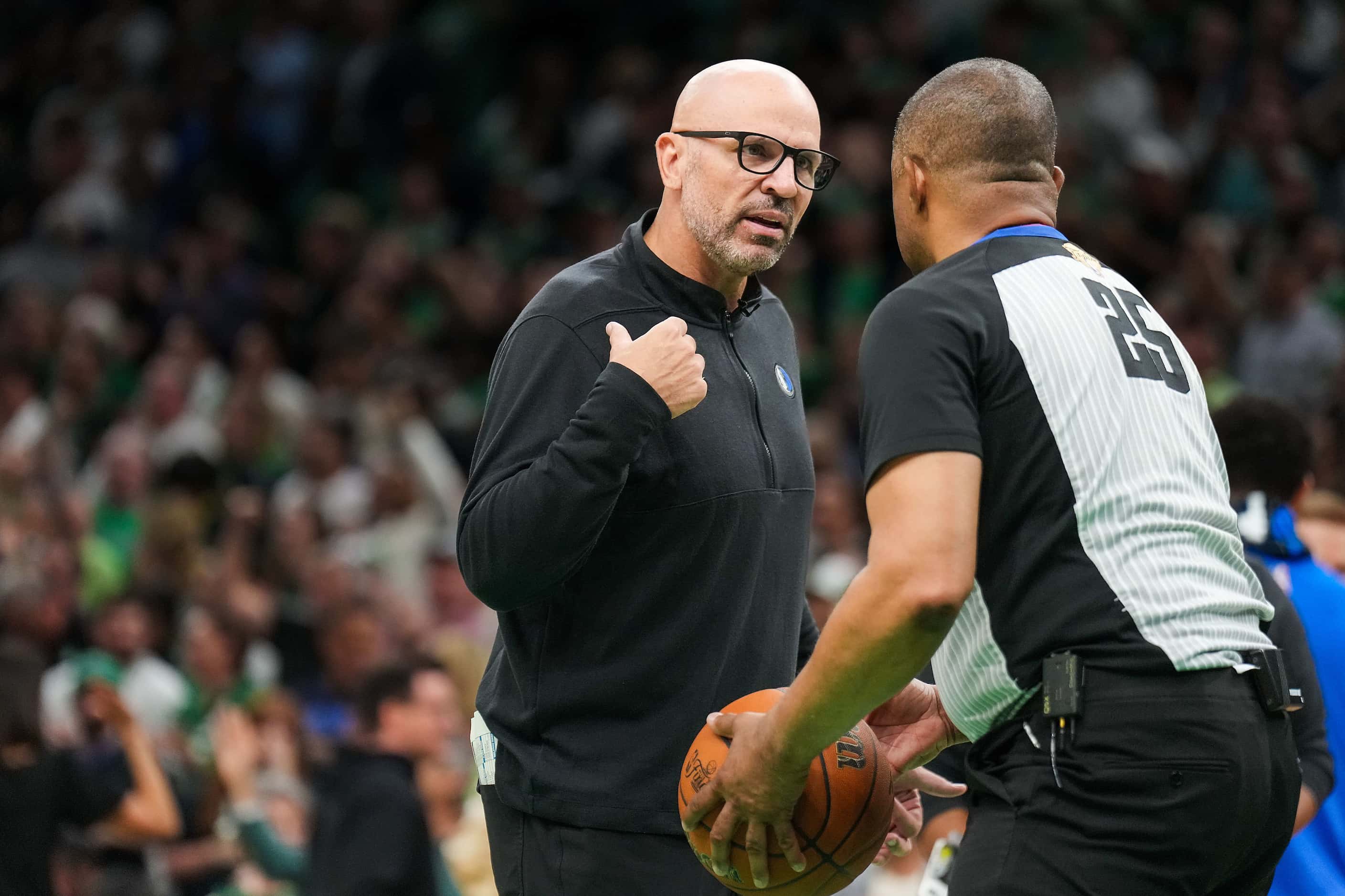 Dallas Mavericks head coach Jason Kidd talks with referee Tony Brothers (25) during the...