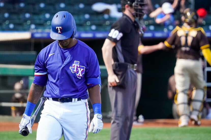 Texas Rangers designated hitter Khris Davis heads to the dugout after striking out end the...