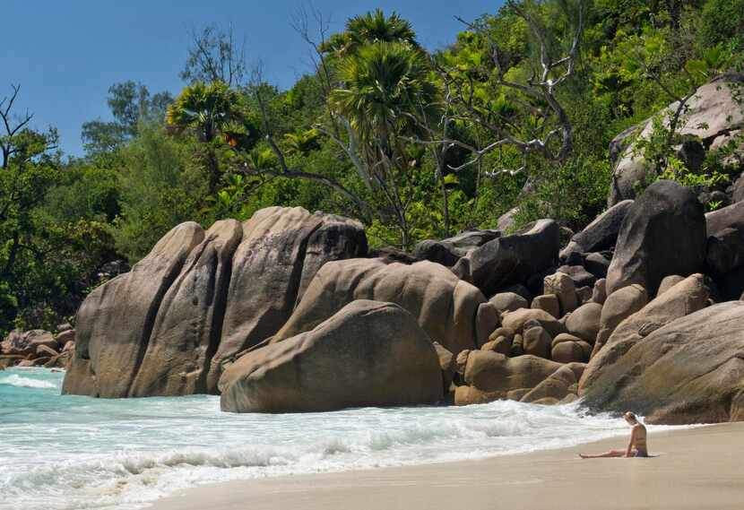 

A beachgoer relaxes on Praslin Island’s Anse Lazio beach, which was recently voted by Trip...
