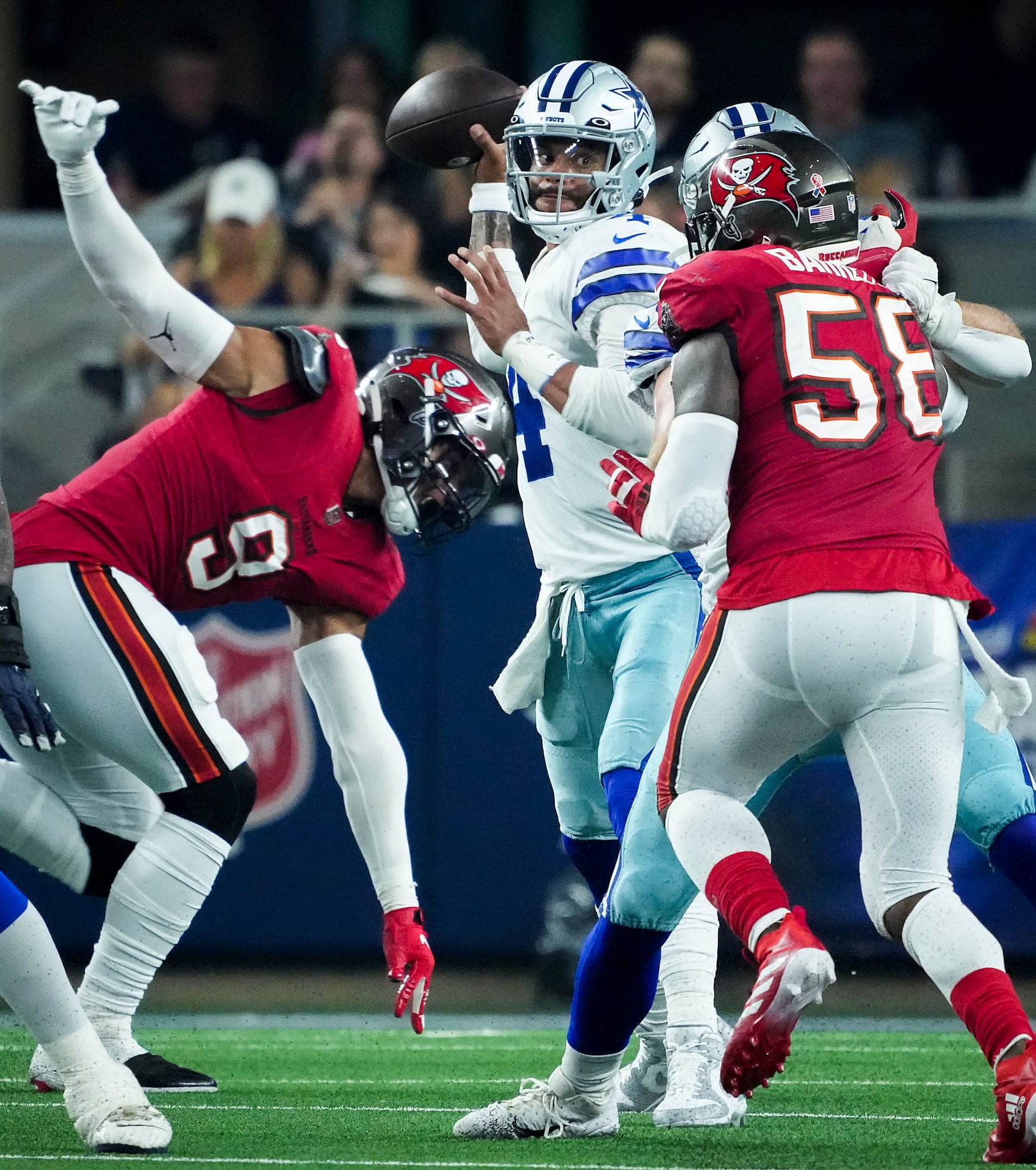 Dallas Cowboys quarterback Dak Prescott (4) throws a pass under pressure from Tampa Bay...