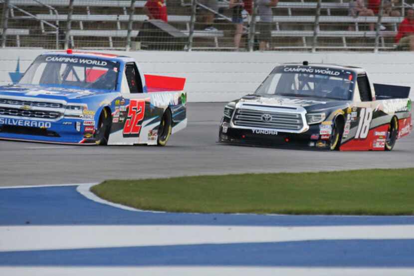 Stewart Friesen (52), Noah Gragson (18) and Todd Gilliland (4) duel for the lead in the...