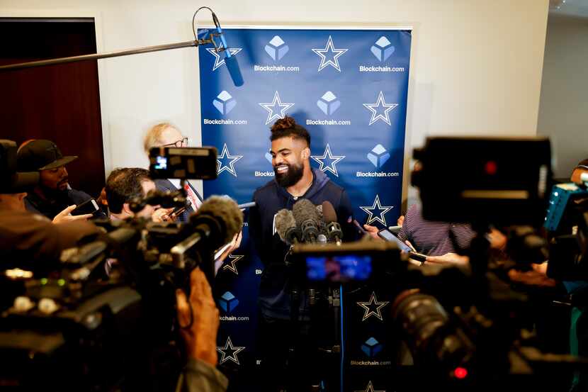 Dallas Cowboys running back Ezekiel Elliott (21) smiles as he talks during a press...