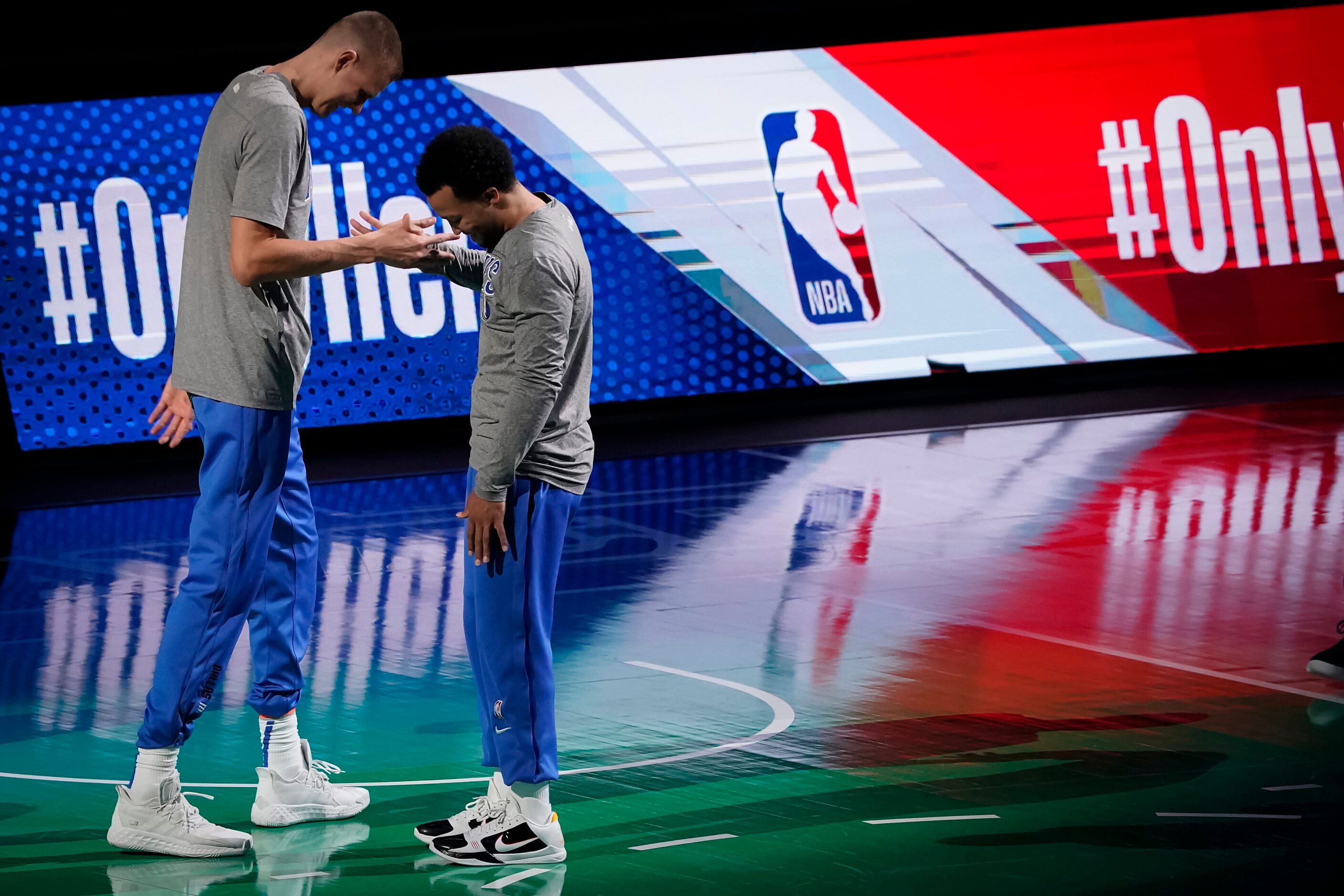 Dallas Mavericks center Kristaps Porzingis (left) takes the floor with guard Jalen Brunson...