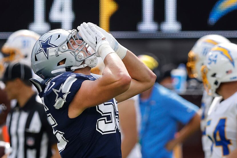 Dallas Cowboys linebacker Leighton Vander Esch (55) lets loose the wolf howl after sacking...