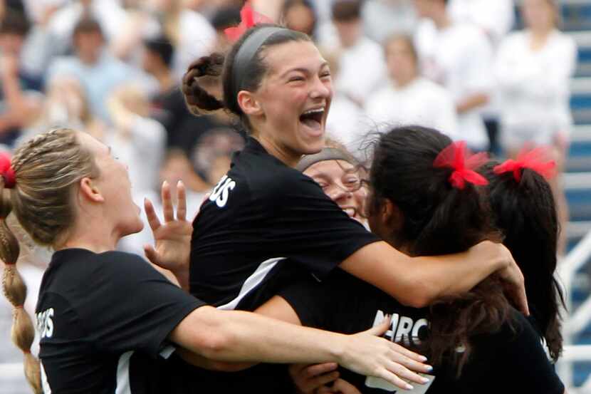 Flower Mound Marcus forward Bella Campos (7), right, celebrates with teammates including...