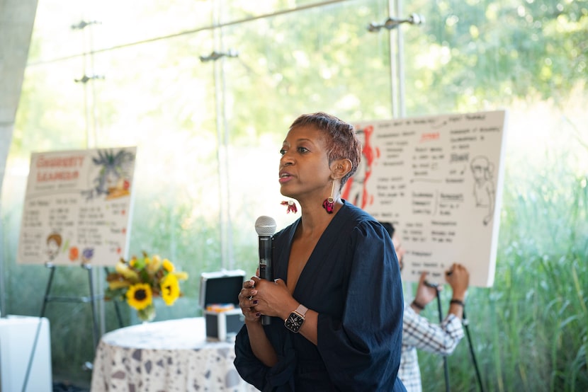 Katrice Hardy, executive editor of The Dallas Morning News, holding a microphone while she...