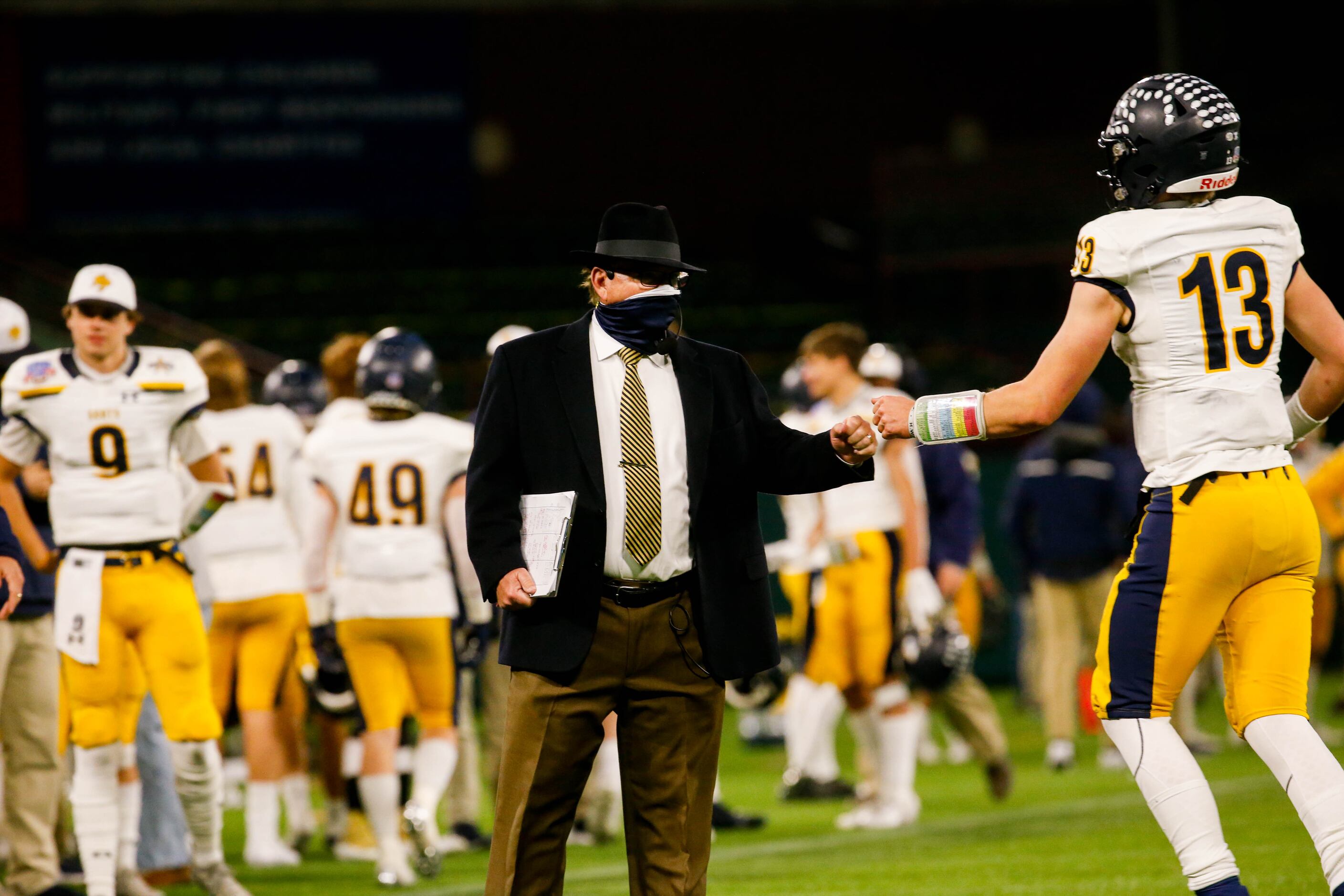 Highland Park's coach Randy Allen fist bumps Grant McVeigh (13) after a play in the fourth...