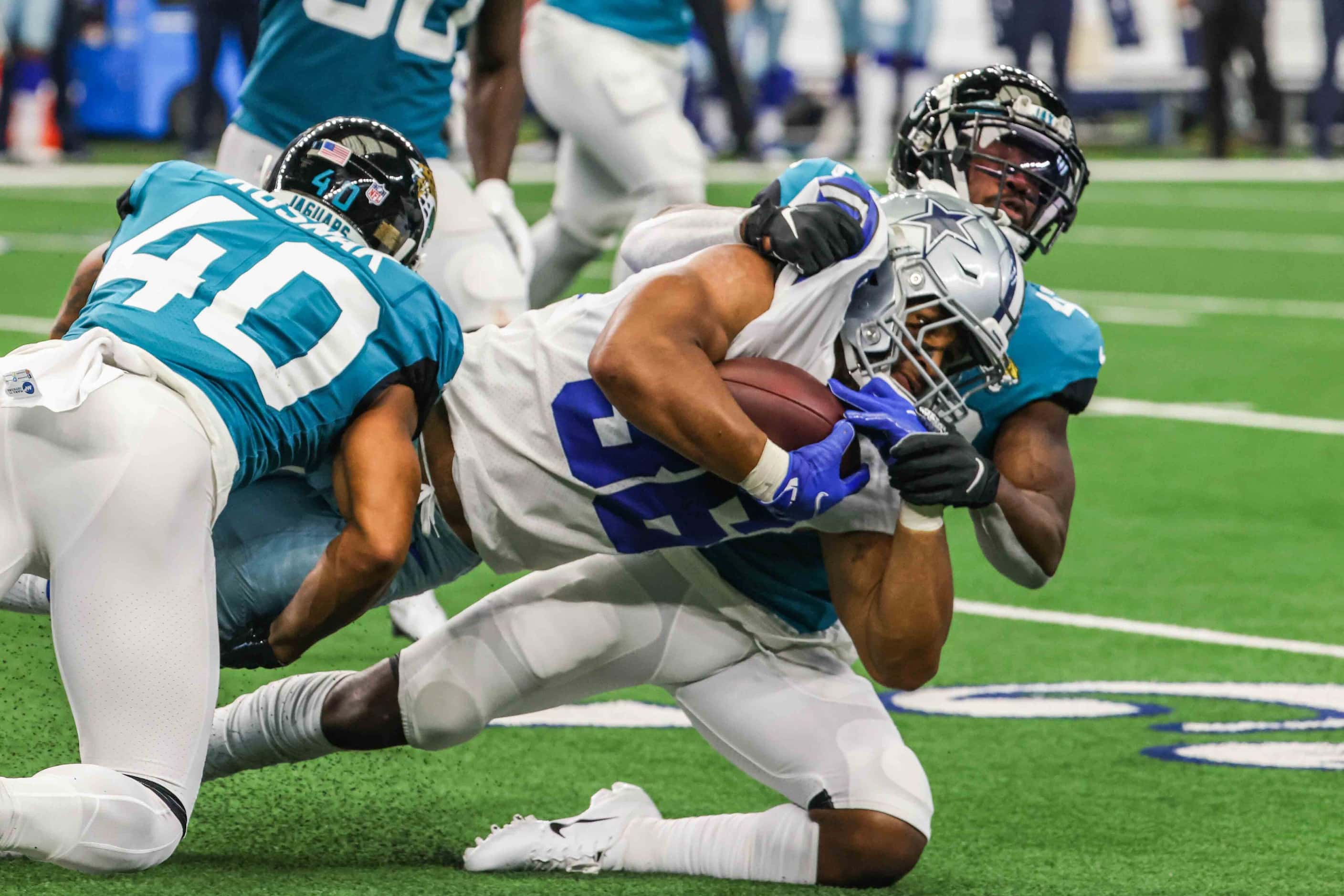 Dallas Cowboys running back Brenden Knox, 36, falls after being tackled by Jacksonville...