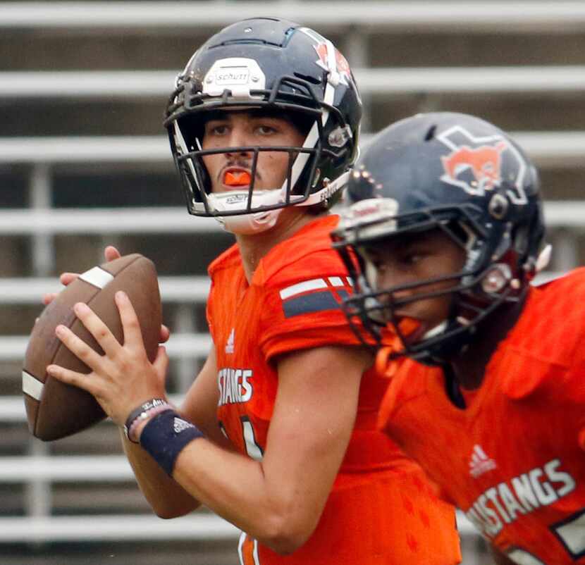Sachse quarterback Anthony Beltran (14) looks for an open receiver during 4th quarter action...