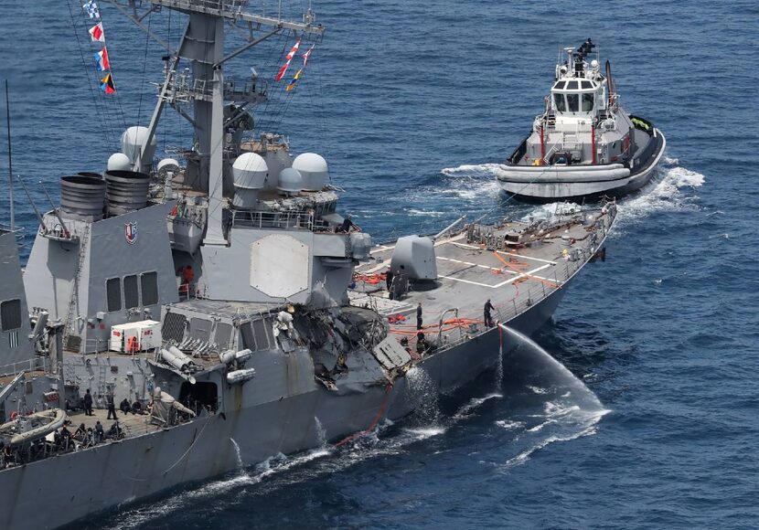 The damaged USS Fitzgerald is seen near a tugboat off the Shimoda coast after it collided...