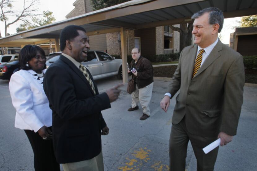 Mayor Mike Rawlings (right) talks to Eddie Casnave and Glenda Thomas, residents at Arbor...
