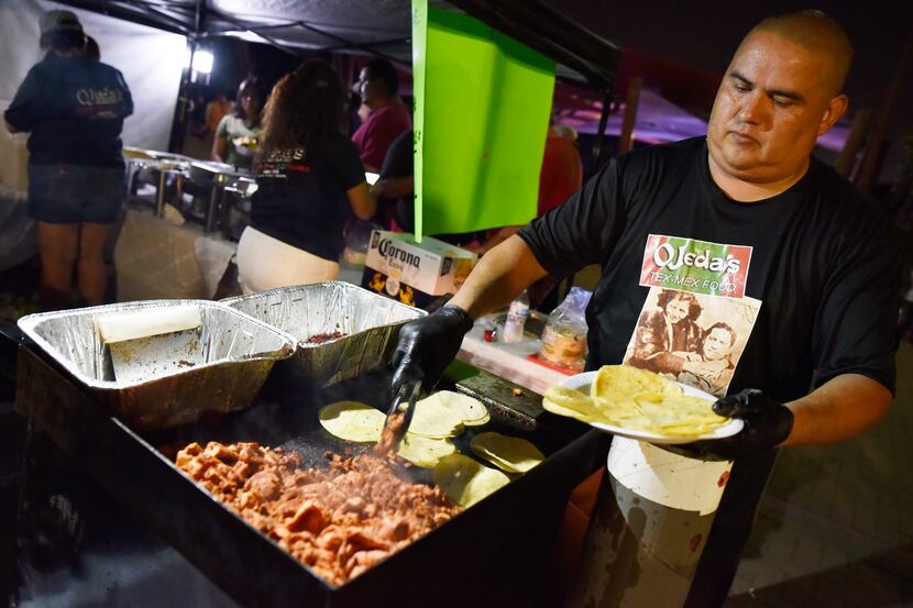 Oscar Carrillo of Ojeda's Restaurant prepares pork tacos at the 2019 Latino Heritage...