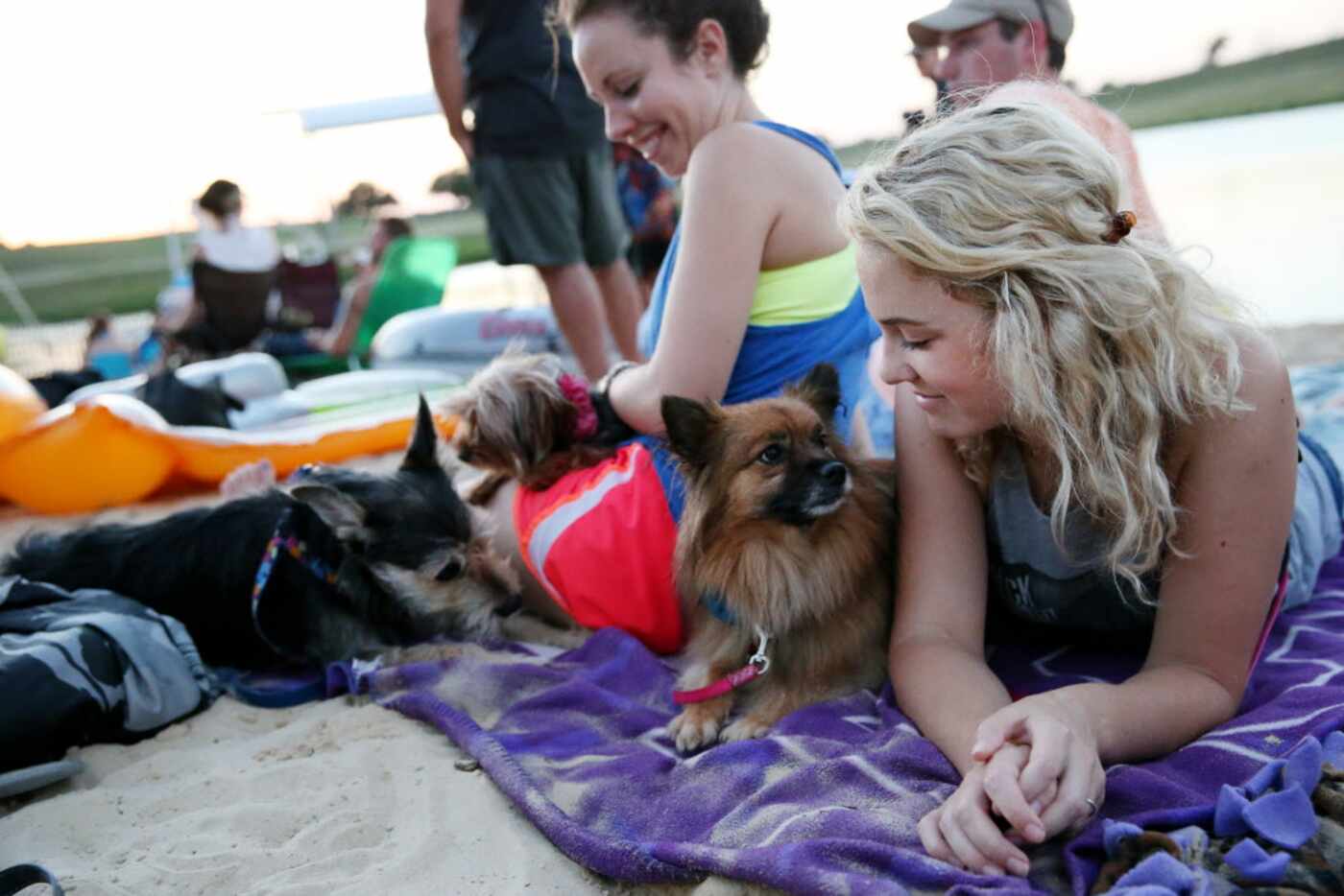 Nicole Chaffee, of Fort Worth, lies with dog Harlow on the beach on the Trinity River during...