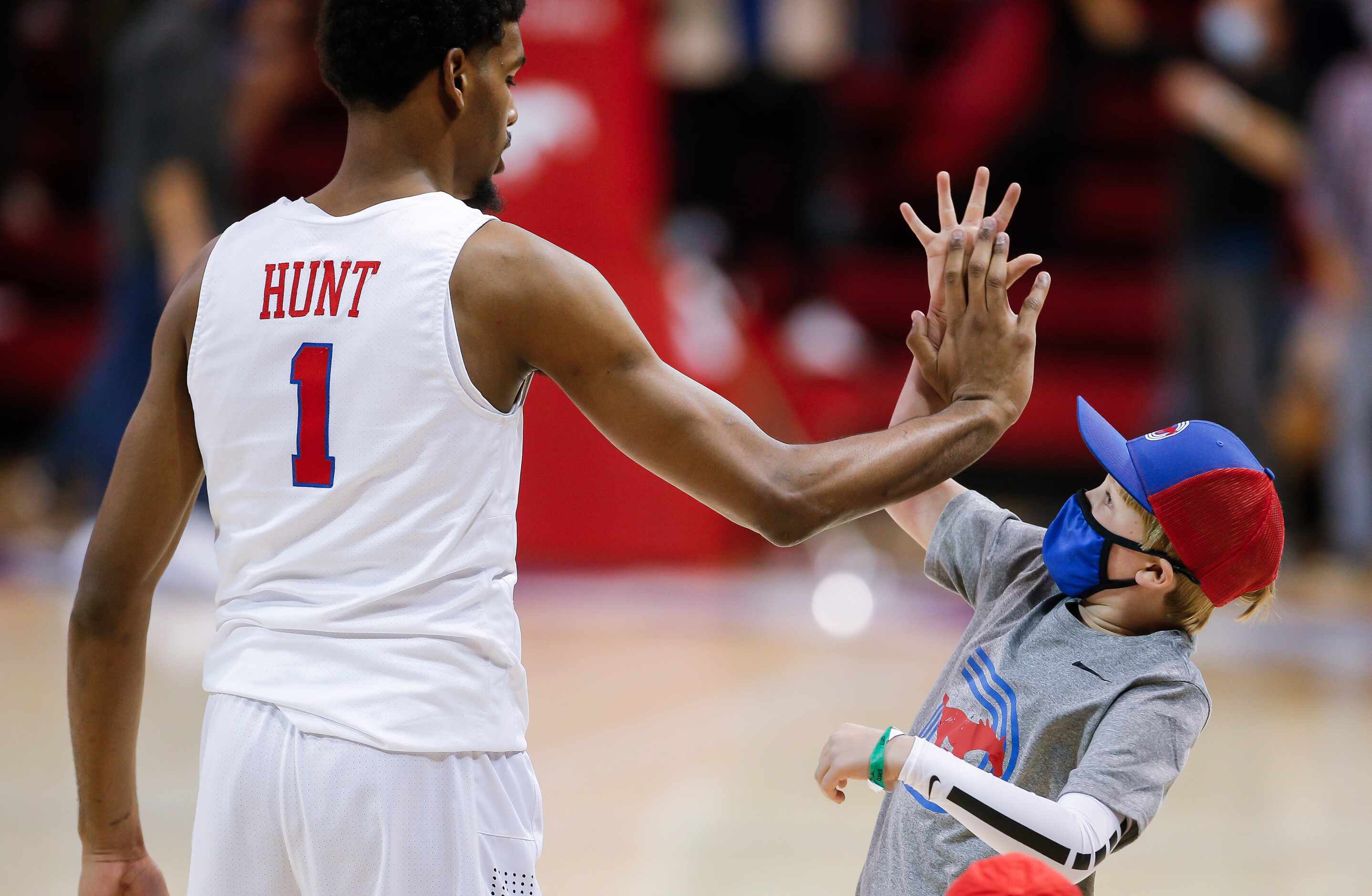 SMU forward Feron Hunt (1) high-fives a fan after a college basketball game against Memphis...