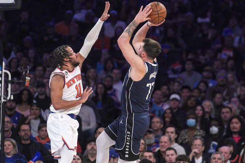 Dallas Mavericks guard Luka Doncic, right, shoots over New York Knicks guard Jalen Brunson,...