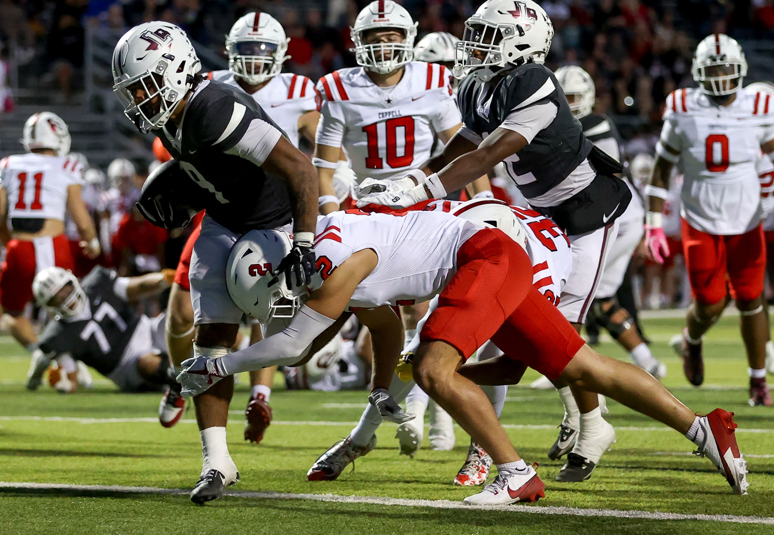 Lewisville running back Tenel Hill (9) gets into the endzone for a 7 yard touchdown run...