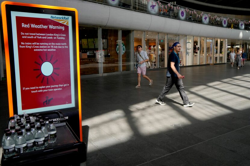 A sign at King's Cross railway station warns of train cancellations due to the heat in...