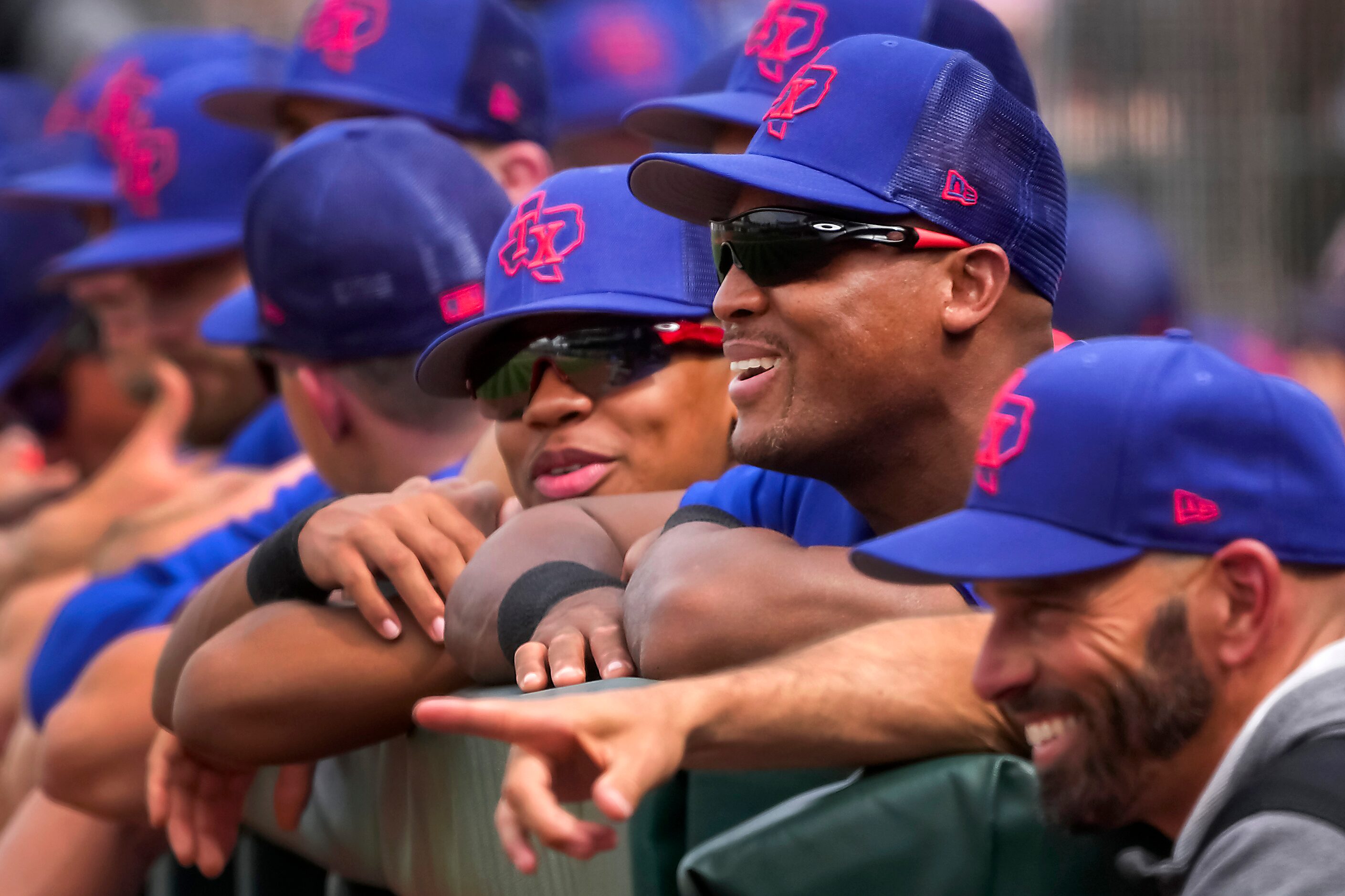 Former Texas Rangers third baseman Adrian Beltre (center) watches from the dugout with his...