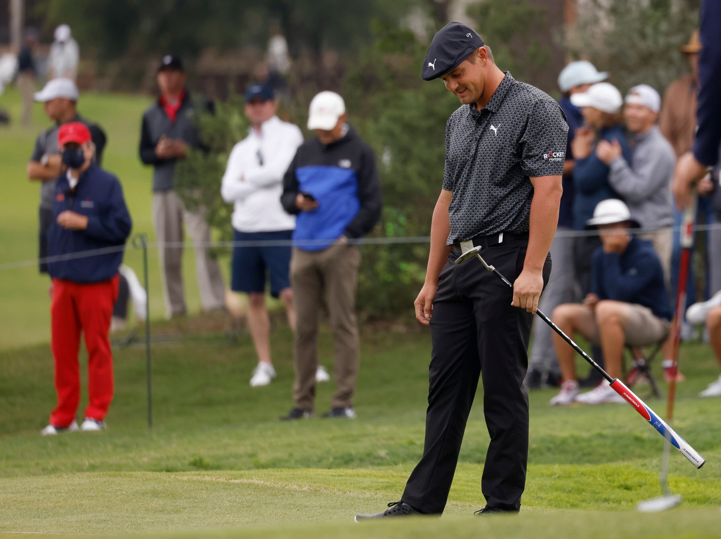 Bryson DeChambeau reacts after missing a putt for a possible birdie on the 15th hole during...