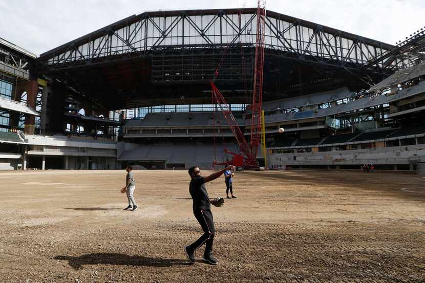 Texas Rangers Delino DeShields throws the baseball to a teammate at Globe Life Field in...