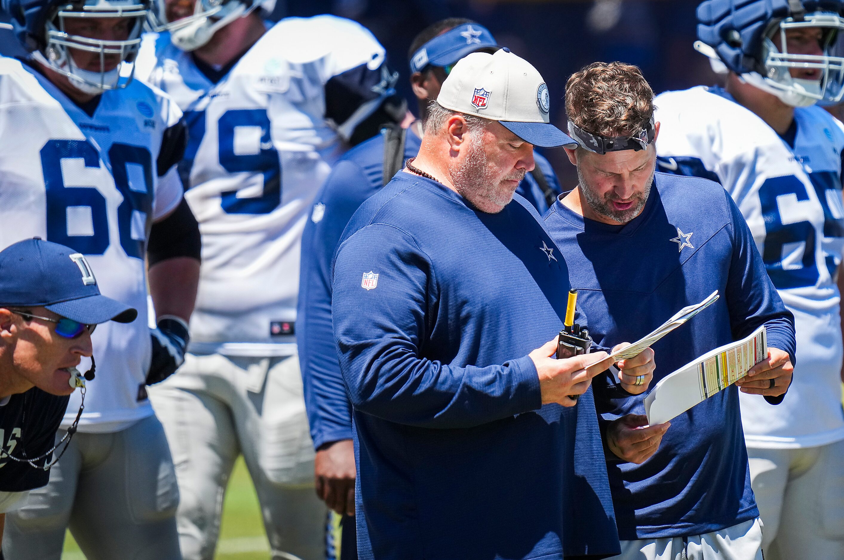 Dallas Cowboys offensive coordinator Brian Shottenheimer (right) confers with head coach...