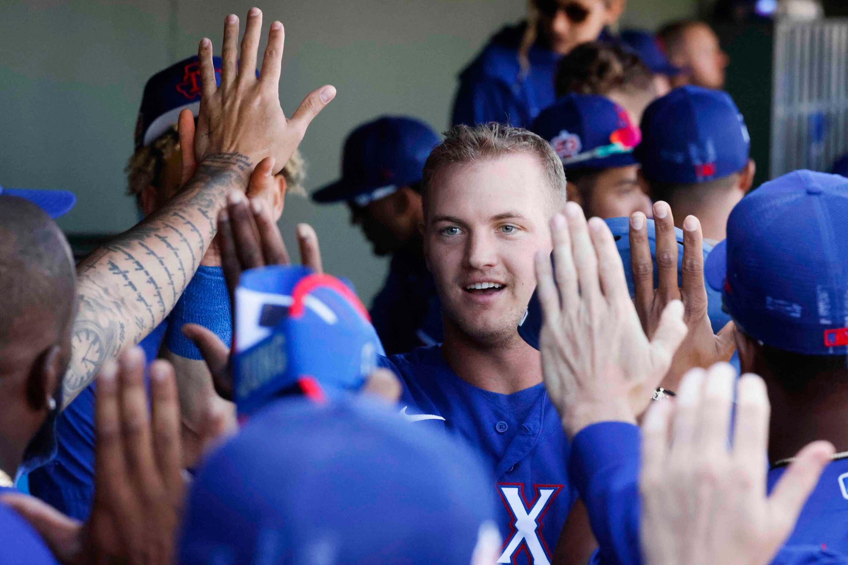 Texas Rangers Josh Jung celebrates after scoring a run during the second inning of a spring...