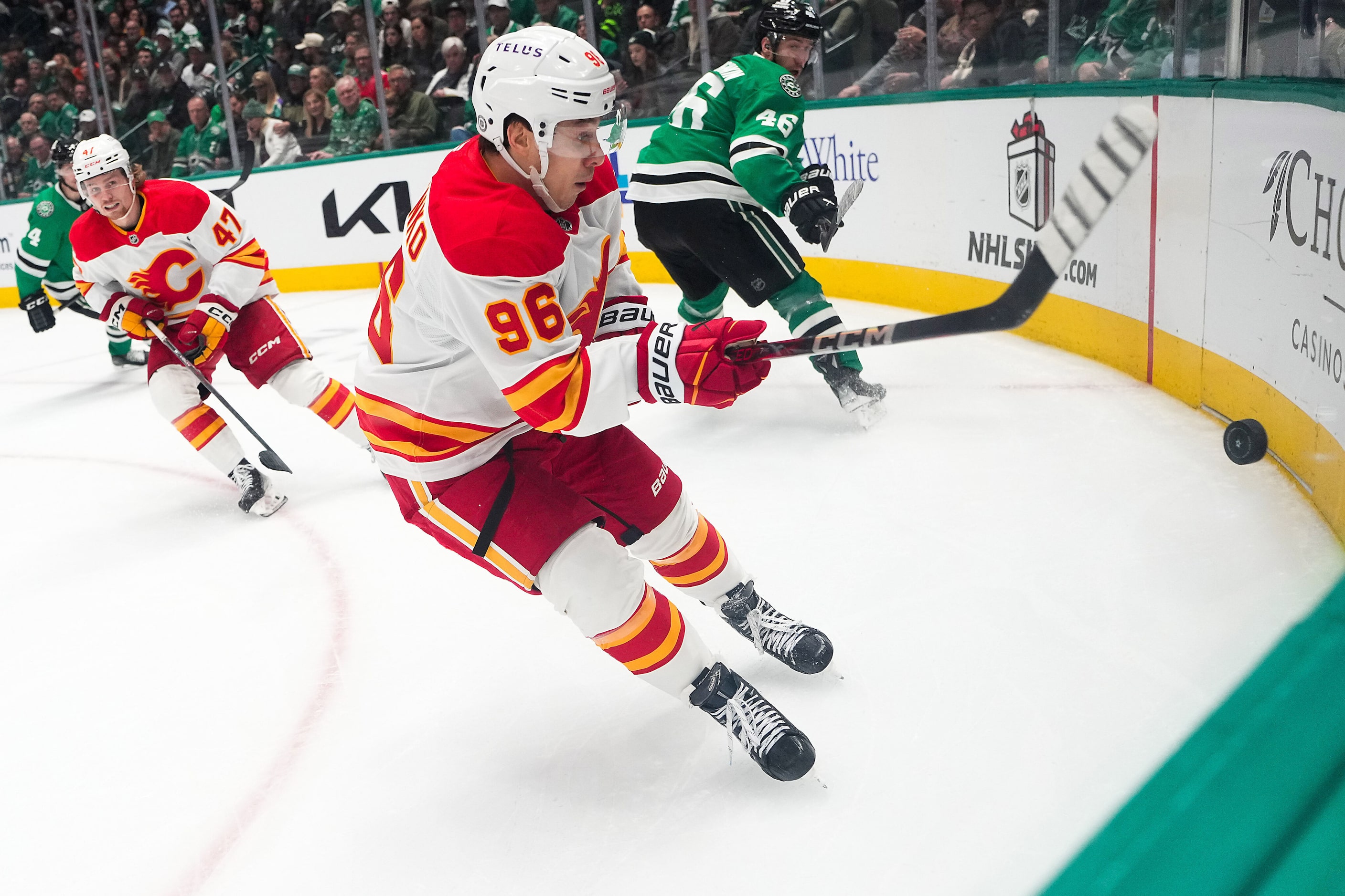 Calgary Flames left wing Andrei Kuzmenko (96) chases the puck in to the corner against...