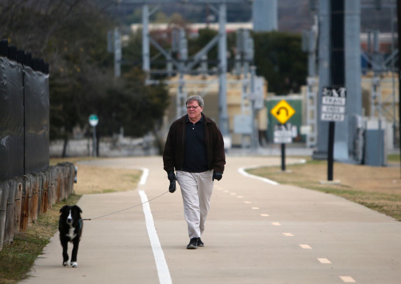 Tim Allen walks his dog Bailer along Northaven Trail in North Dallas. 