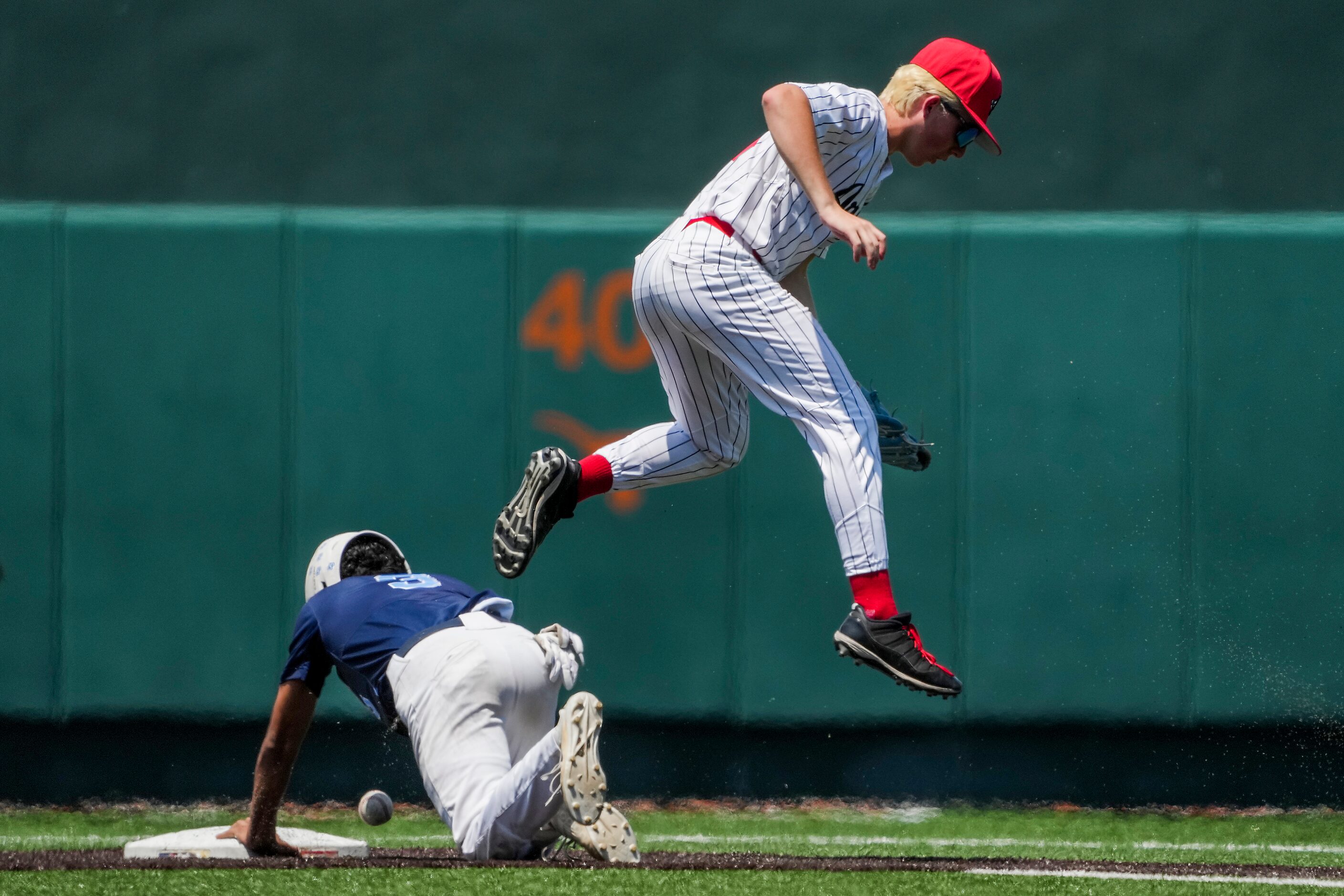 China Spring Gabe Watkins (3) slides under the tag as the ball gets past Argyle shortstop JC...