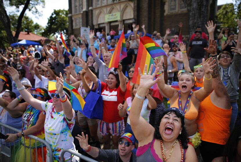 Diana Estrada of Plano, lower right, joined thousands of other people outside Oak Lawn...