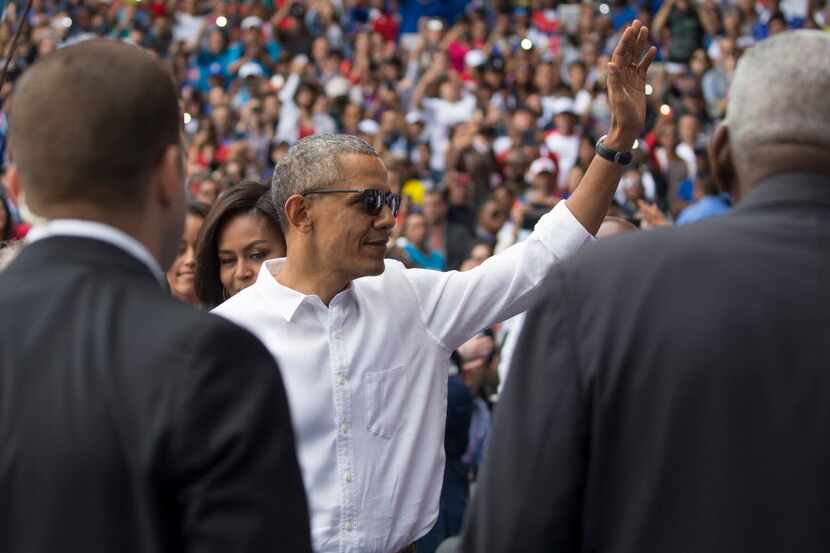 President Barack Obama waves to the crowd  at Estadio Latinoamericano in Havana where he was...