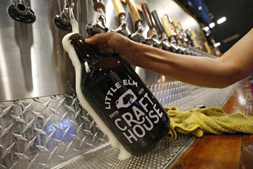 A growler is filled at Little Elm Crafthouse in Little Elm, Texas Aug. 30, 2016.