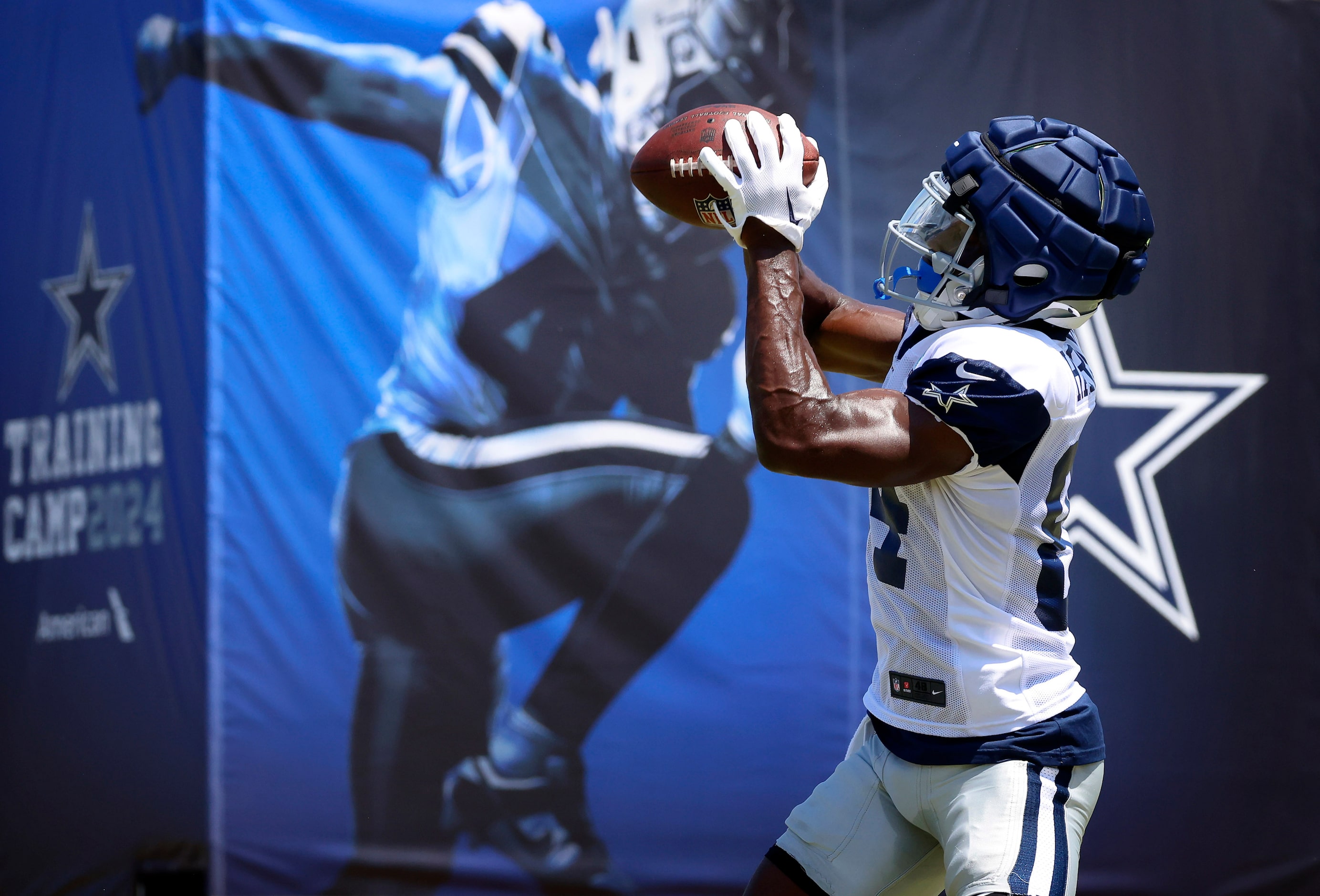 Dallas Cowboys wide receiver Kelvin Harmon (84) comes down with a pass during training camp...