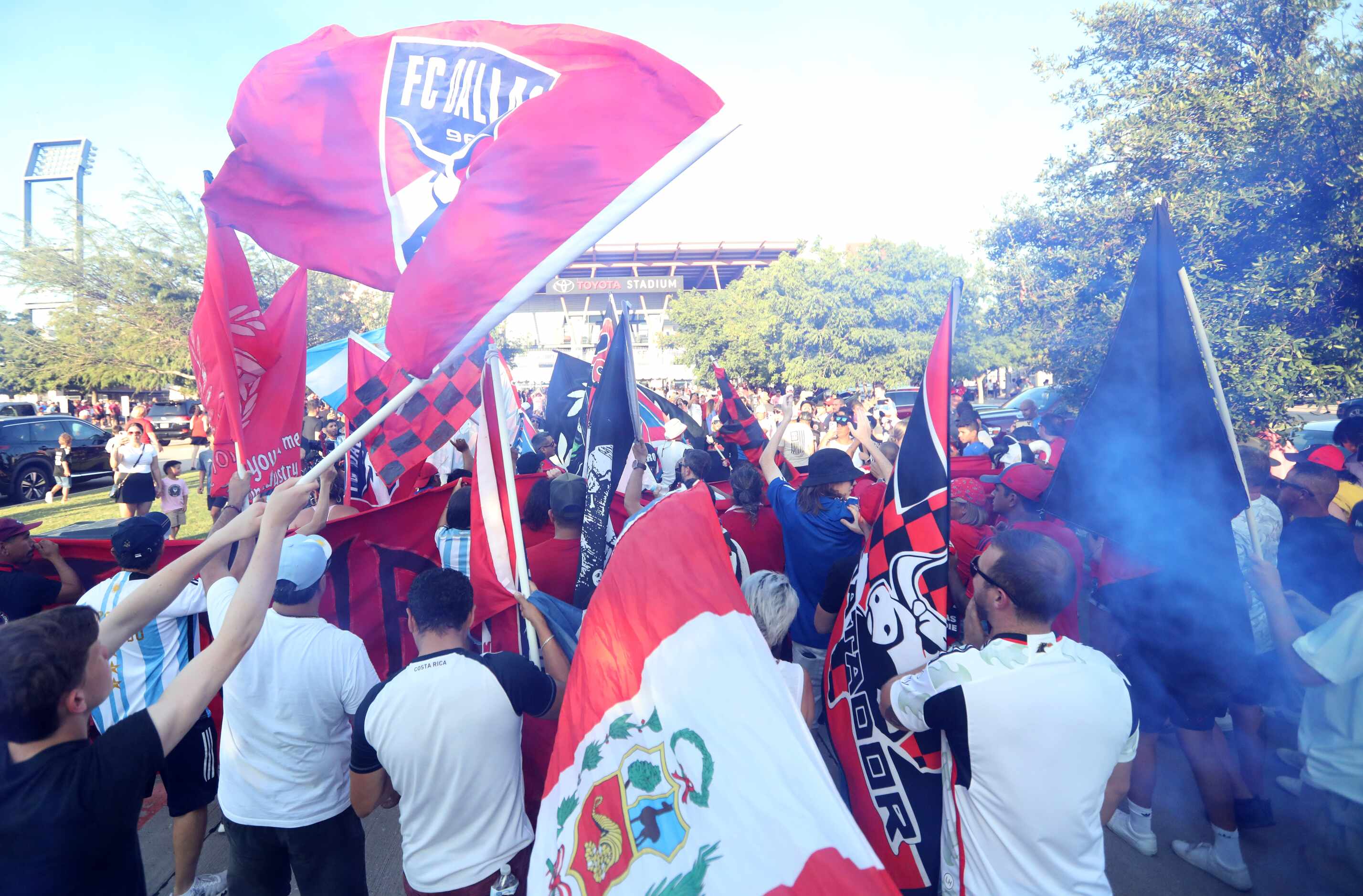 Fans join a parade as the gates to open for an FC Dallas game at Toyota Stadium in Frisco,...