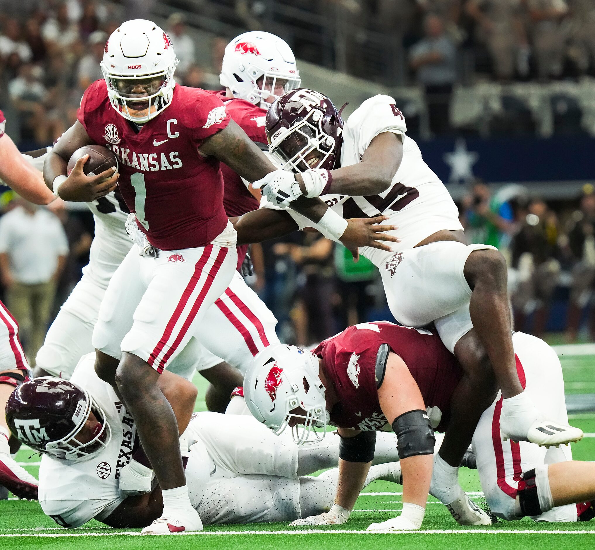 Arkansas quarterback KJ Jefferson (1) is sacked by Texas A&M linebacker Edgerrin Cooper (45)...