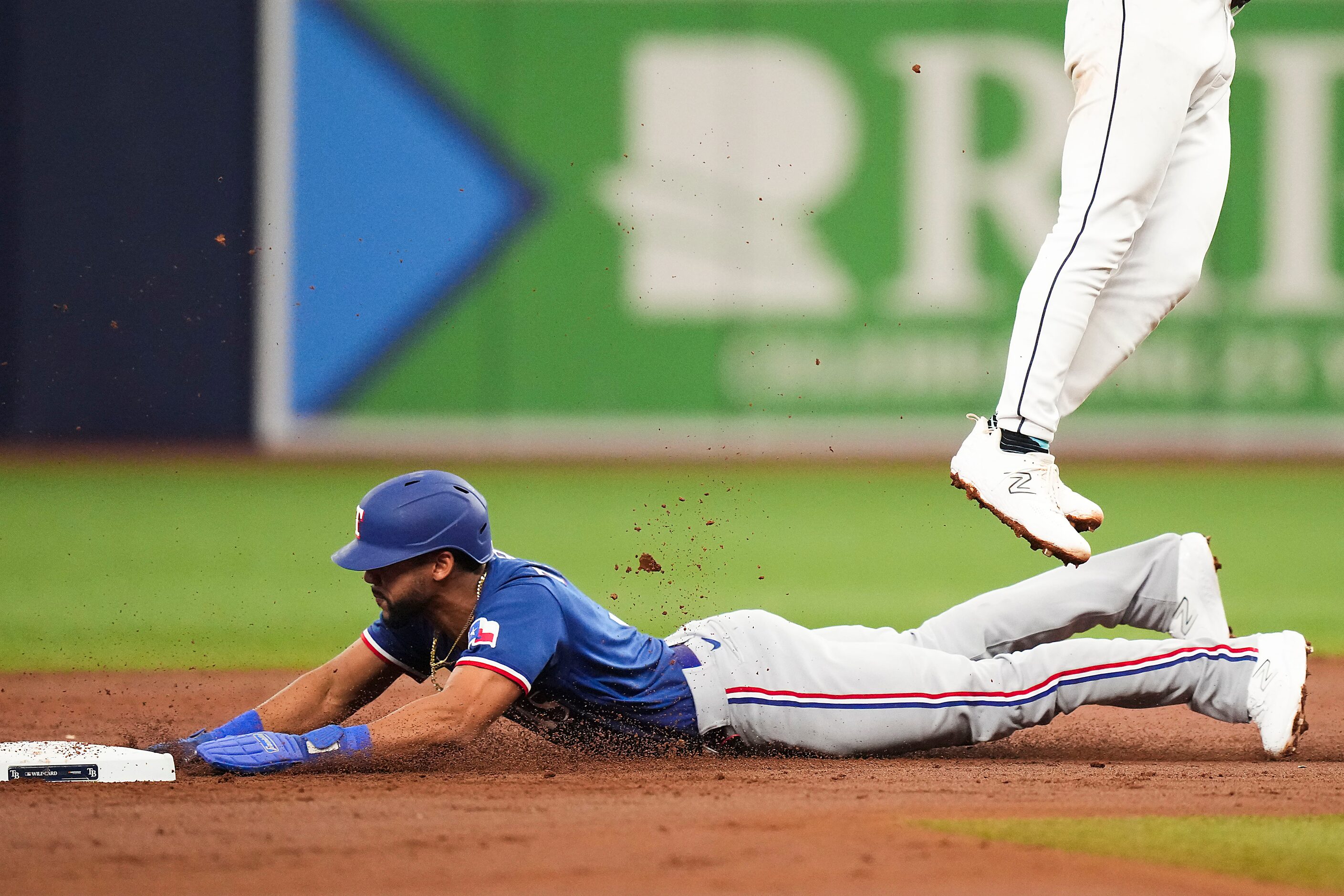 Texas Rangers center fielder Leody Taveras is safe at second base with a stolen base during...