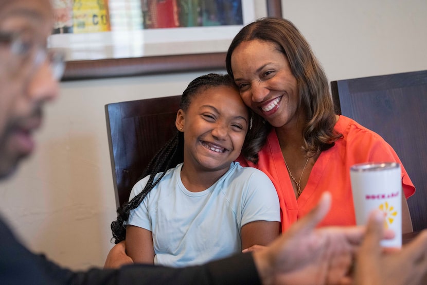 Nine-year-old Sage Sorrell, with her mother, Natalie, listens as her father, Michael, makes...